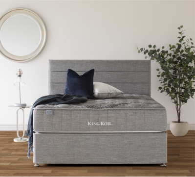Grey upholstered mattress in a modern bedroom.