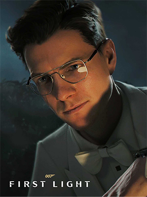 A young man with glasses, wearing a light-colored tuxedo with a bow tie