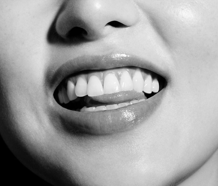 A smiling face showing healthy gums and teeth.